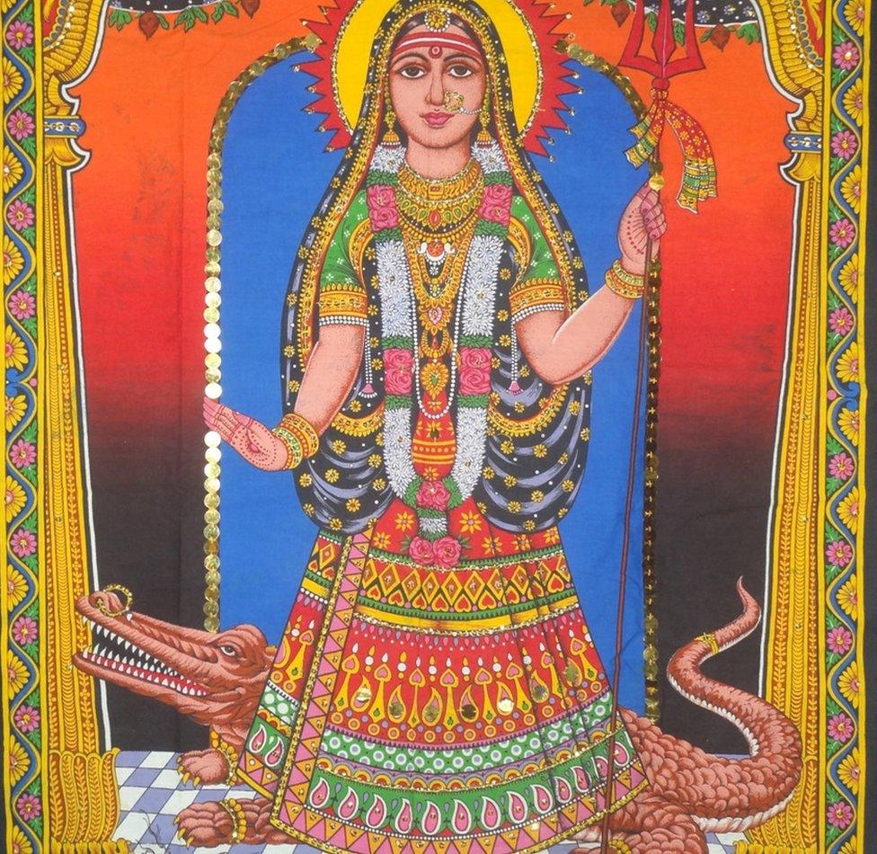 Goddess Khodiyar beside a bejewelled crocodile.