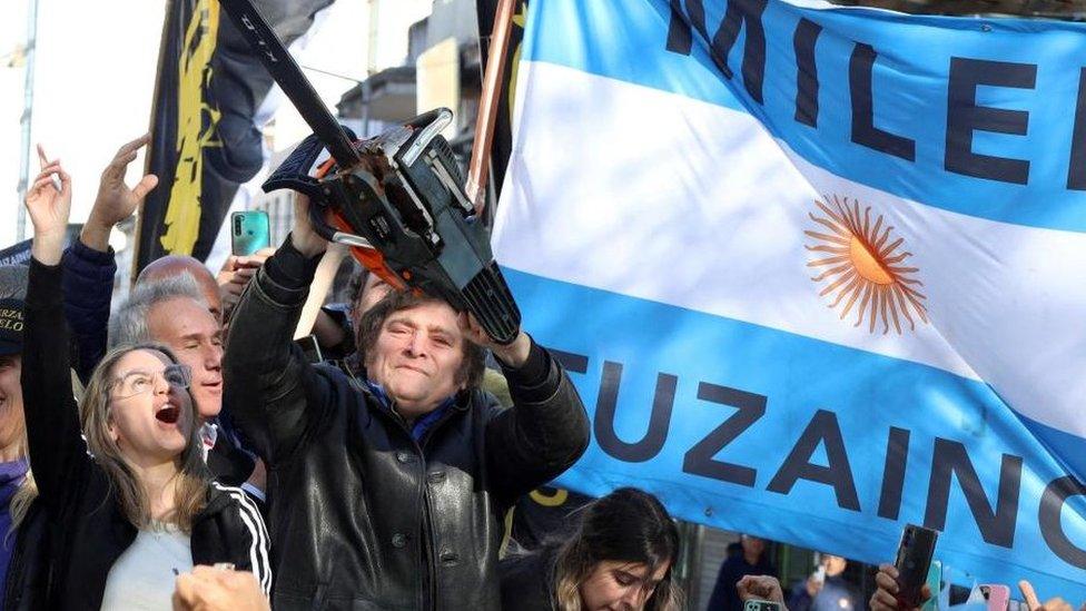 Argentine presidential candidate Javier Milei holds a chainsaw next to Carolina Piparo, candidate for Governor of the Province of Buenos Aires, during a campaign rally, in Buenos Aires, Argentina September 25, 2023.