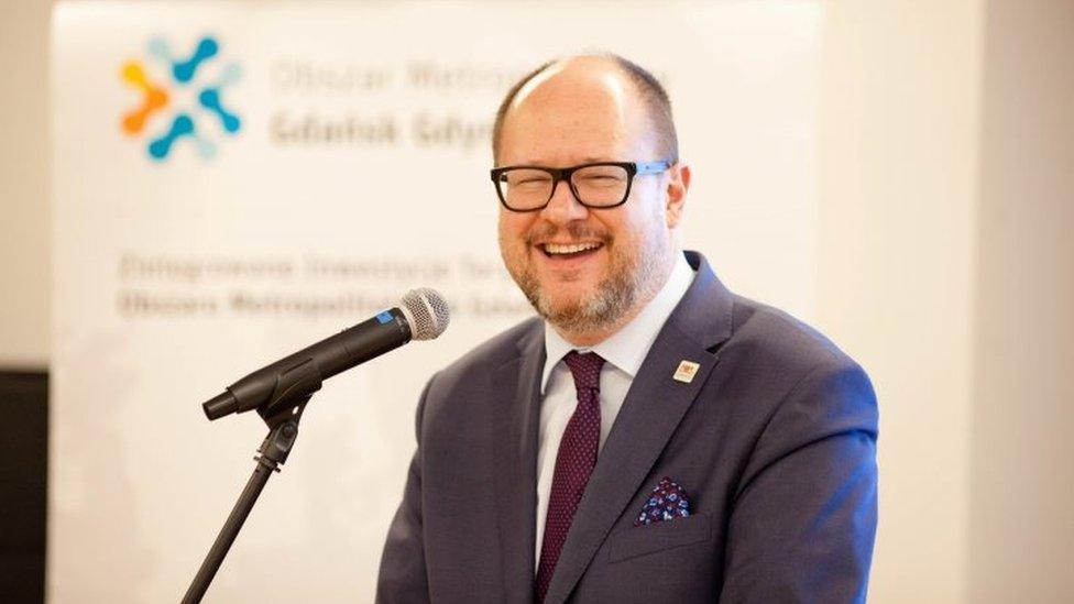 Gdansk"s Mayor Pawel Adamowicz smiles during a December meeting