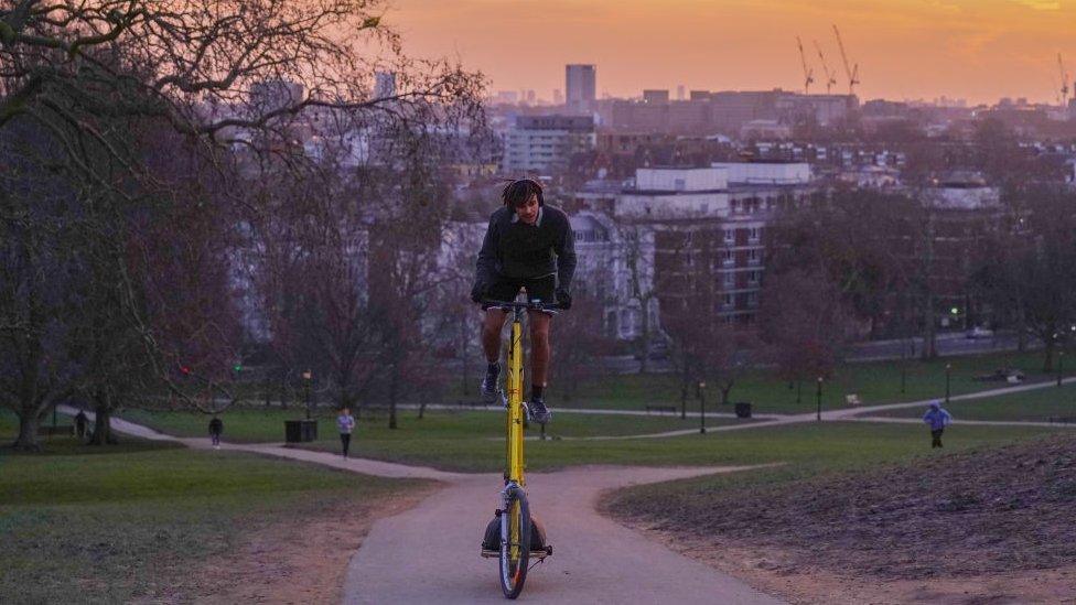 tall bike being ridden up a hill