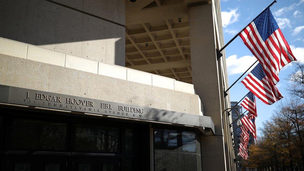 American flags wave outside the J Edgar Hoover FBI Building in Washington, December 2, 2020.