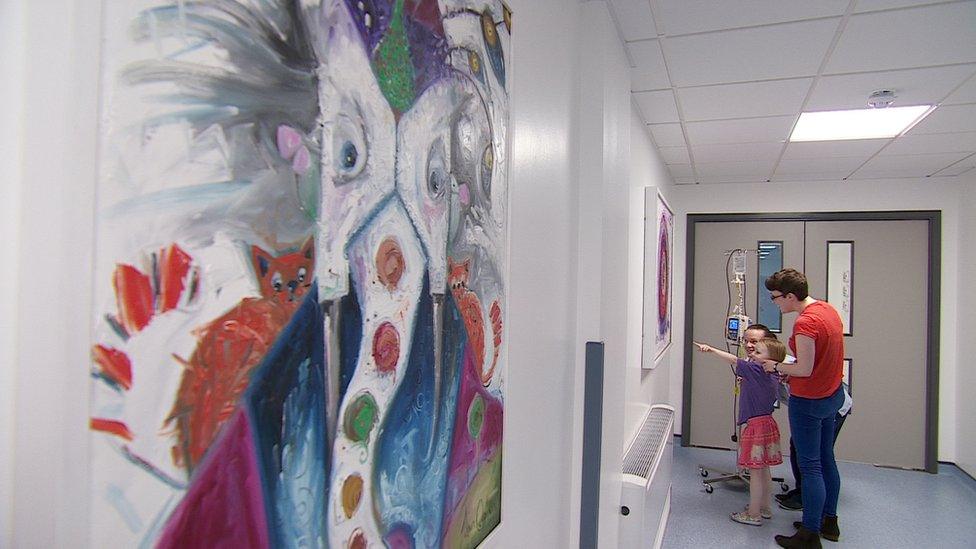 Sadie and her mum Pauline look at a painting of a snail at the Royal Hospital for Sick Children