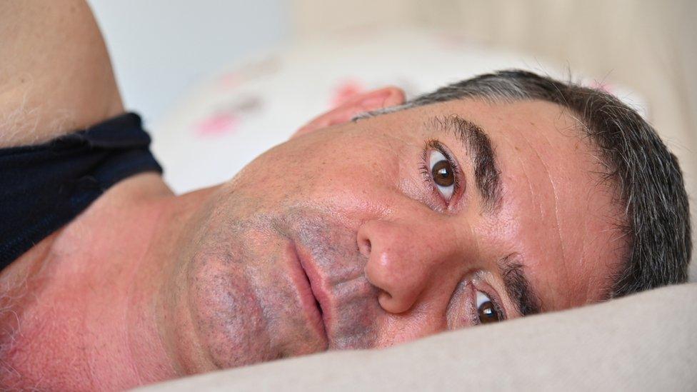 Middle aged man in bed