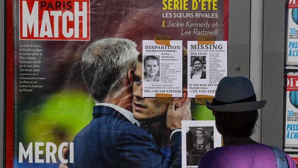 A woman looks at portraits of missing victims of the Bastille Day terror attack on the Promenade des Anglais on July 16, 2016 in Nice, France.