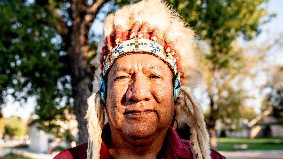 Hanley Frost Sr wearing a headdress - also known as a war bonnet