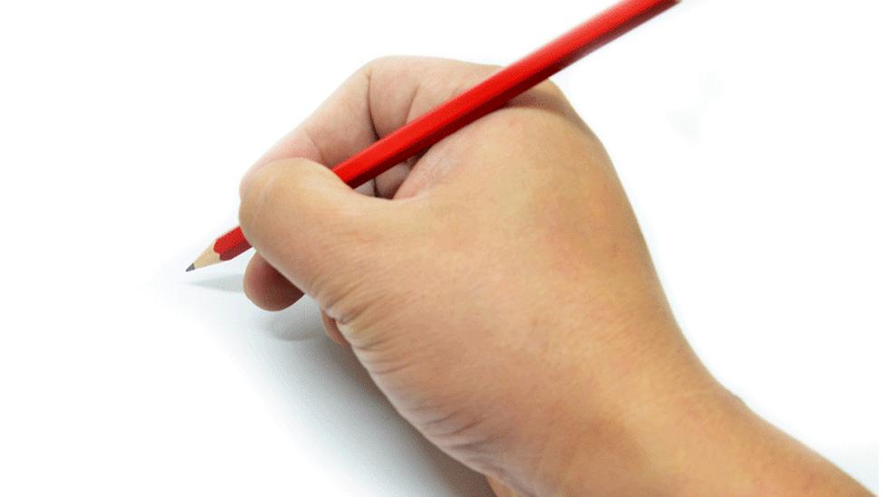 Hand holding pencil