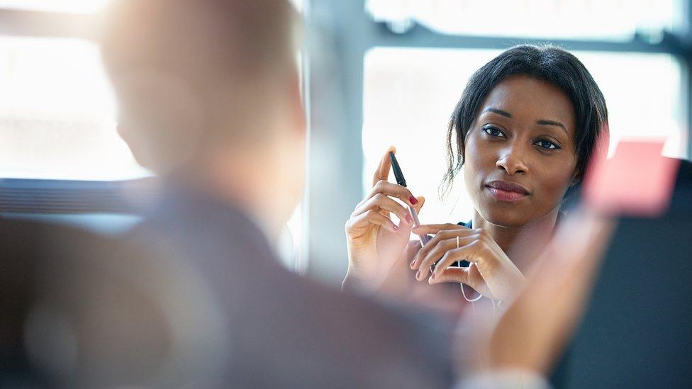 Businesswomen discussing plans with a colleague