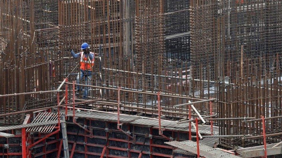 A man works on a construction site of a residential building in Mumbai, India, October 31, 2016