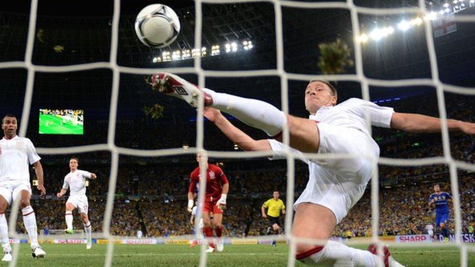 John Terry clears the ball off the line against Ukraine in Euro 2012