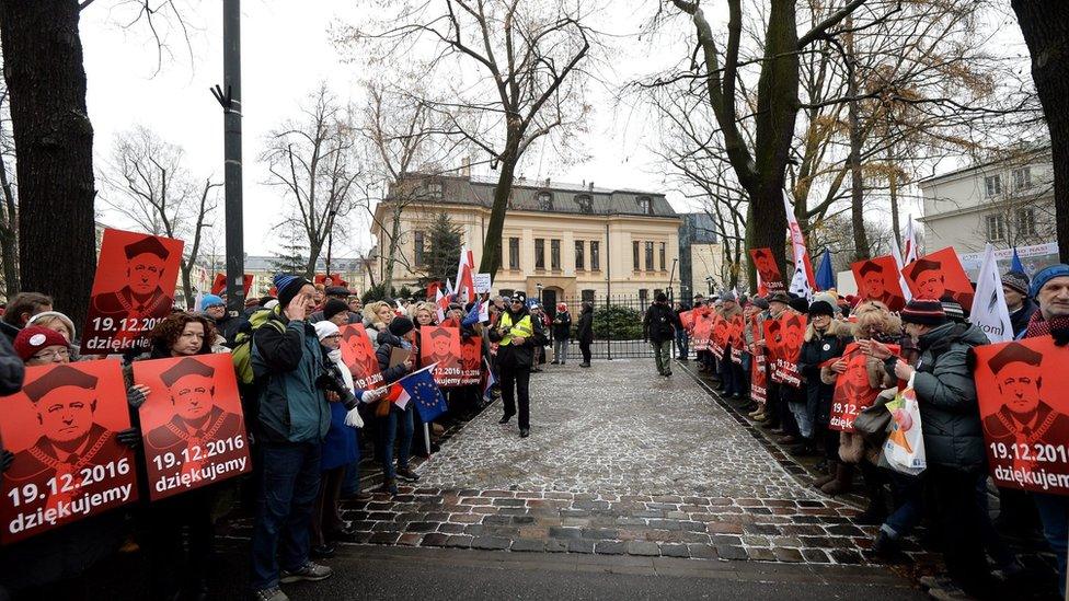 People hold banners with an image of Constitutional Tribunal (TK) President judge Andrzej Rzeplinski and with words "Thank You".