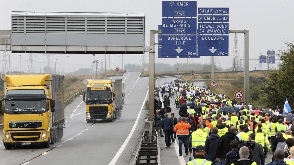 Harbour workers, storekeepers and residents march to participate in a human chain protest demonstration against the migrant situation in Calais