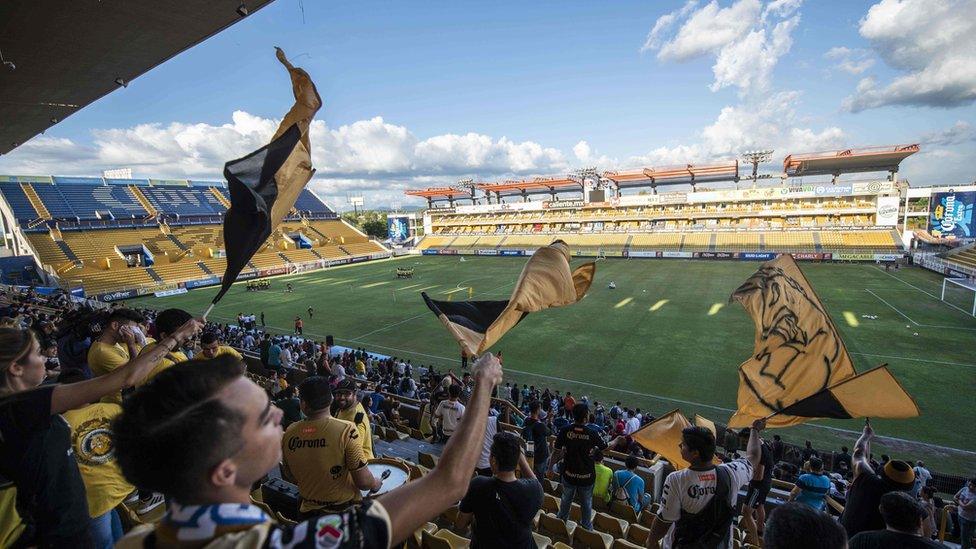 Fans wave flags at the Banorte stadium in Culiacan, Sinaloa State, Mexico, on September 10, 2018