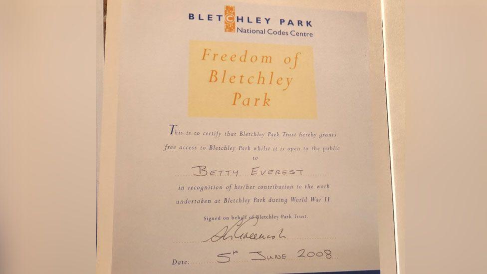 A letter from Bletchley Park to Betty. The card reads: "This is to certify that Bletchley Park Trust hereby grants free access to Bletchley Park while it is open to the public to Betty Everest in recognition of her contribution to the work undertaken at Bletchley Park during World War II." 
