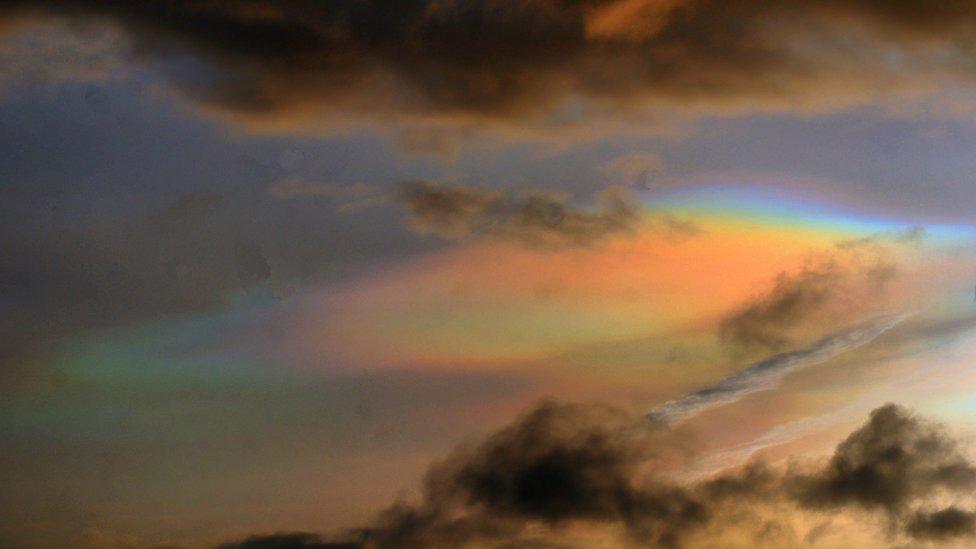 Rainbow cloud looms over Peel on the Isle of Man