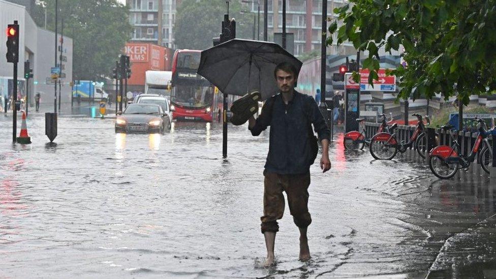 Pedestrian walking through floodwater