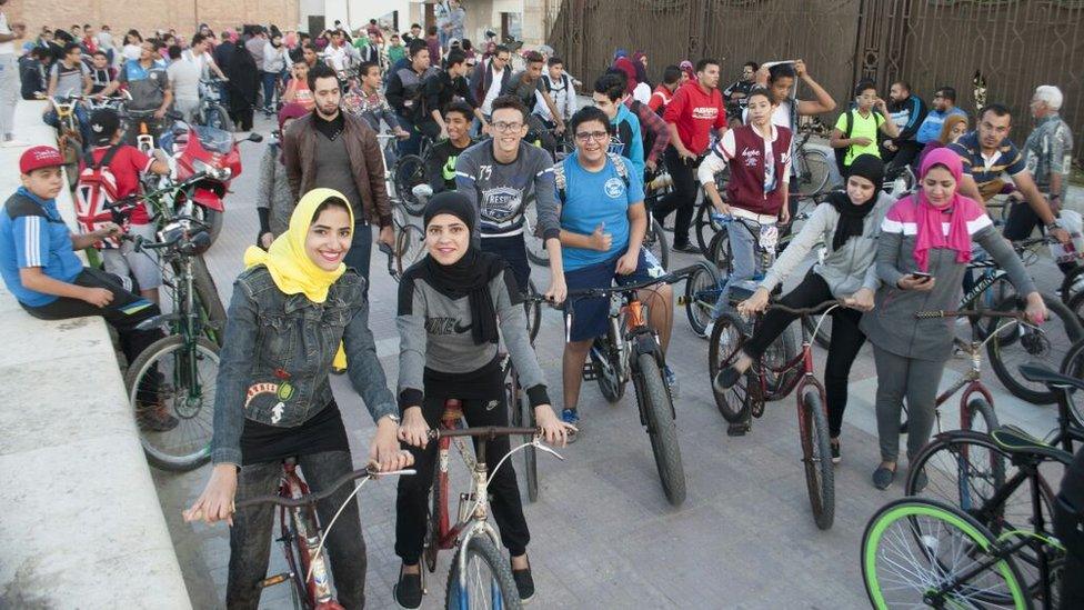 Girls and boys on their bikes during the ride in Port Said