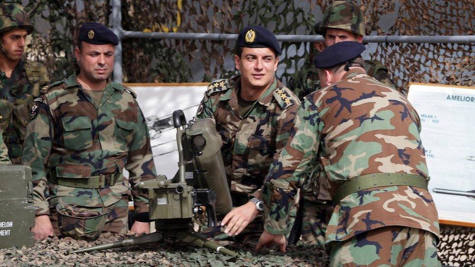 Lebanese army soldiers inspect a Milan anti-tank missile launcher during a hand-over ceremony for a shipment of French weapons at Beirut international airport (20 April 2015)