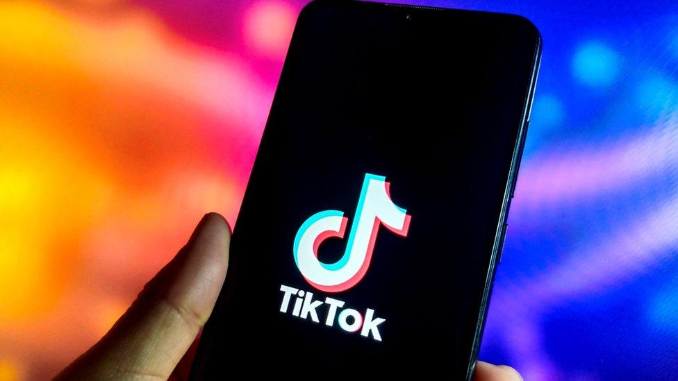 A phone with the TikTok logo