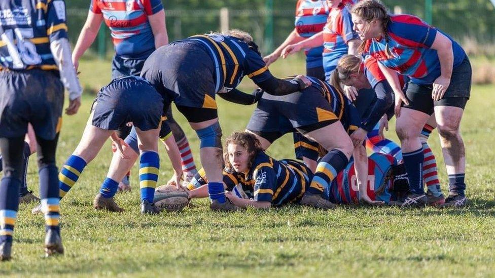 A rugby scrum on the pitch