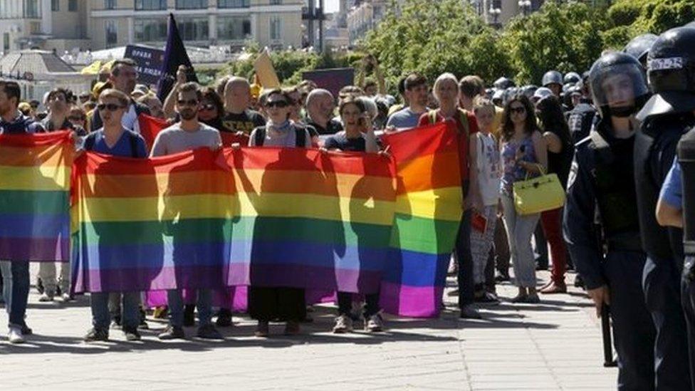 Participants of the Equality March rally in Kiev in 2015, as police stand guard