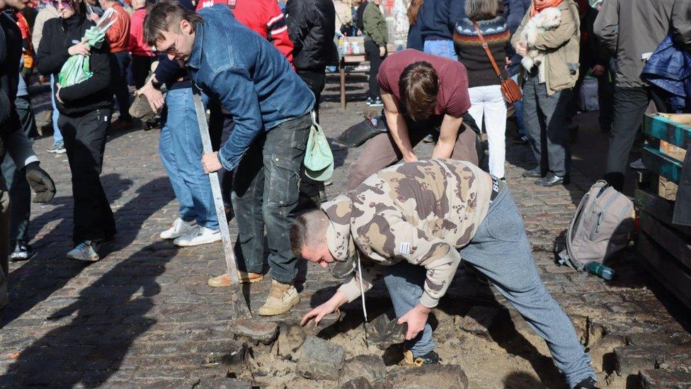 Local people remove cobblestones on Pusher Street