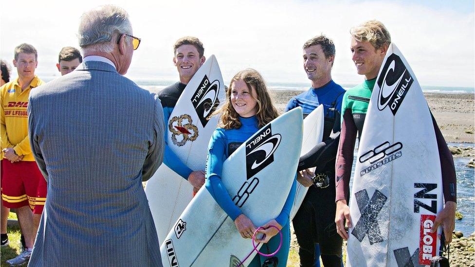 Prince Charles talks with surfers near the town of New Plymouth