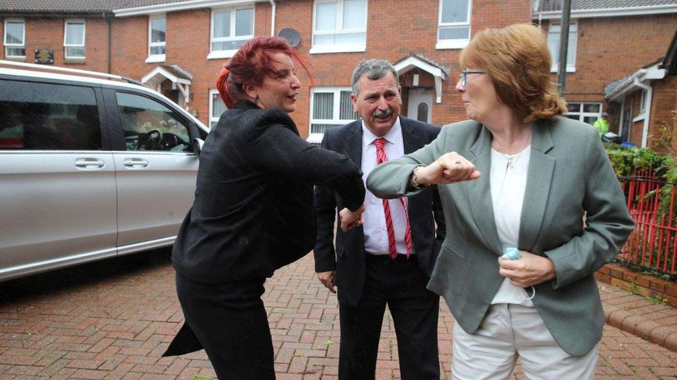 Louise Haigh performing an elbow bump with one of the family members of a victim of the Ballymurphy shootings