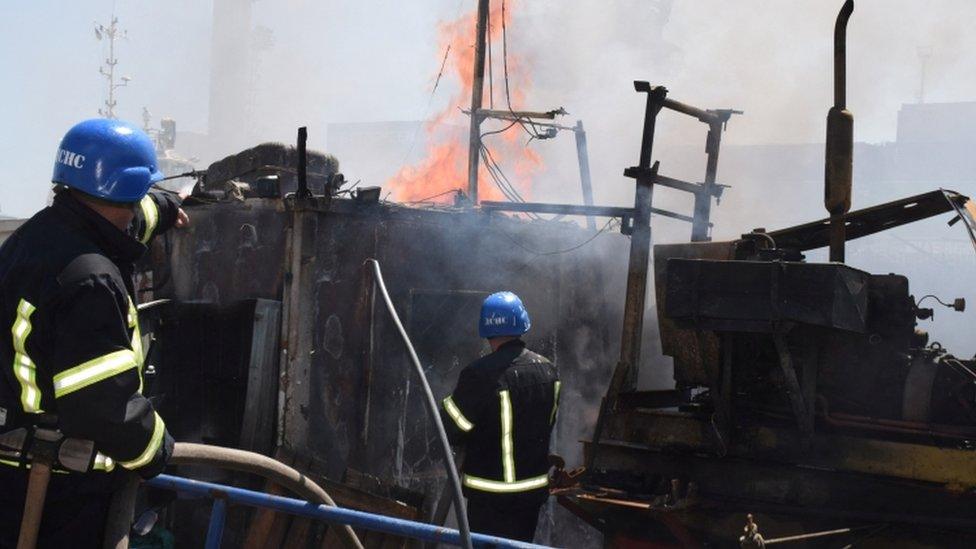 Firefighters at the site of the missile strike in Odesa