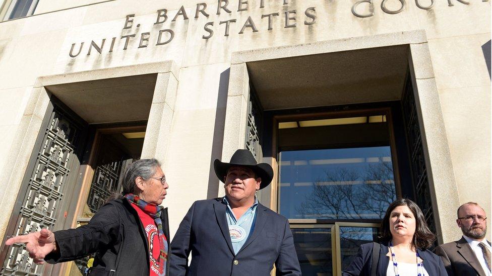 Cheyenne River Sioux Chairman Harold Frazier (C) talks to Madonna Thunder Hawk, left, of the Oohenumpa band of the Cheyenne River Sioux Tribe, before speaking to reporters outside federal court in Washington, Monday, Feb. 13, 2017