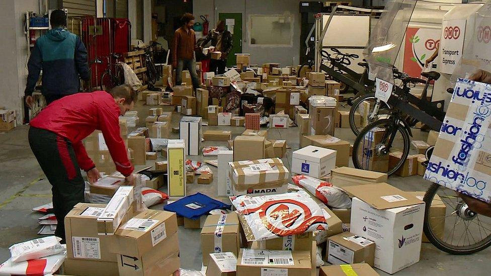 man sorting through parcels