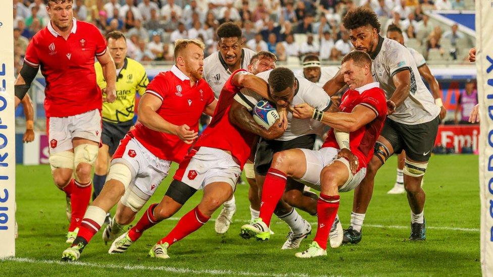 Fiji's Josua Tuisova tacked by Gareth Thomas of Wales