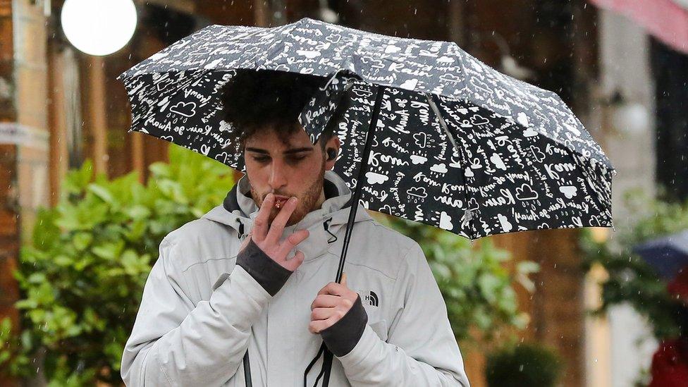 A man smoking a cigarette in London