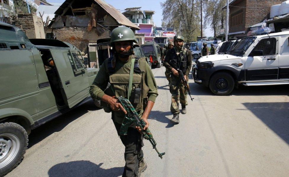 Indian army soldiers patrol during a gun fight with militants in Kachdoora, southern Kashmir