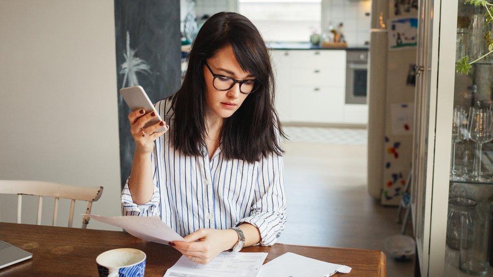 Young woman with bills