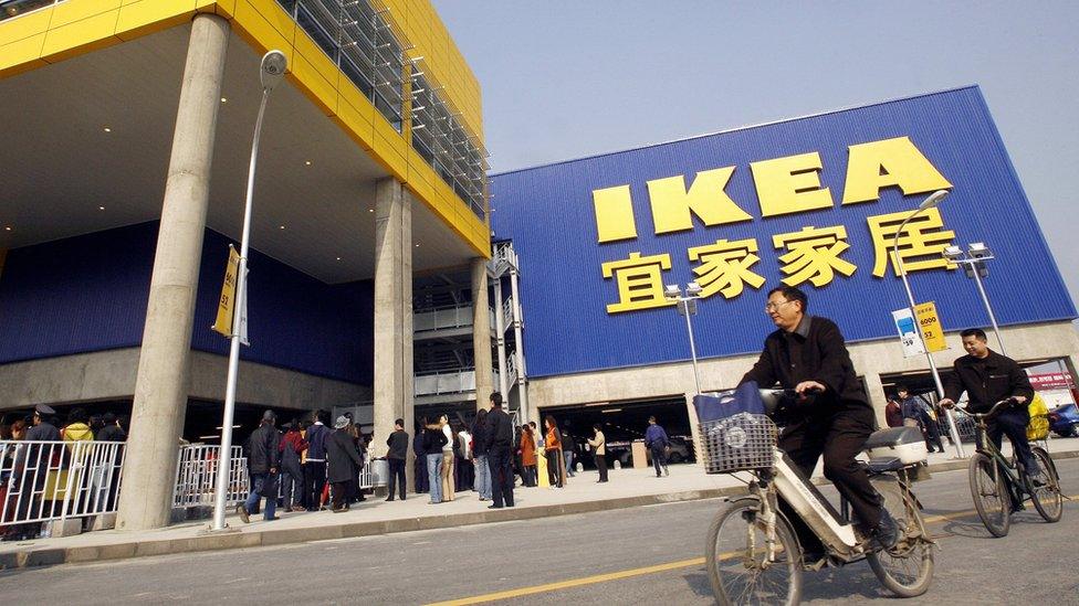 Customers cycle past an Ikea in China's west Chengdu