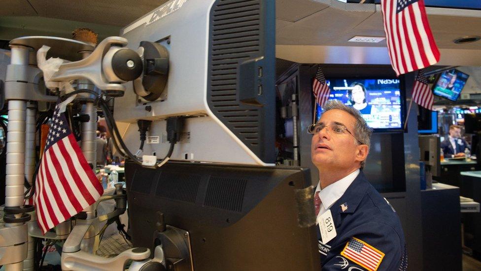 Traders work on the floor at the closing bell of the Dow Industrial Average at the New York Stock Exchange on August 16, 2018 in New York