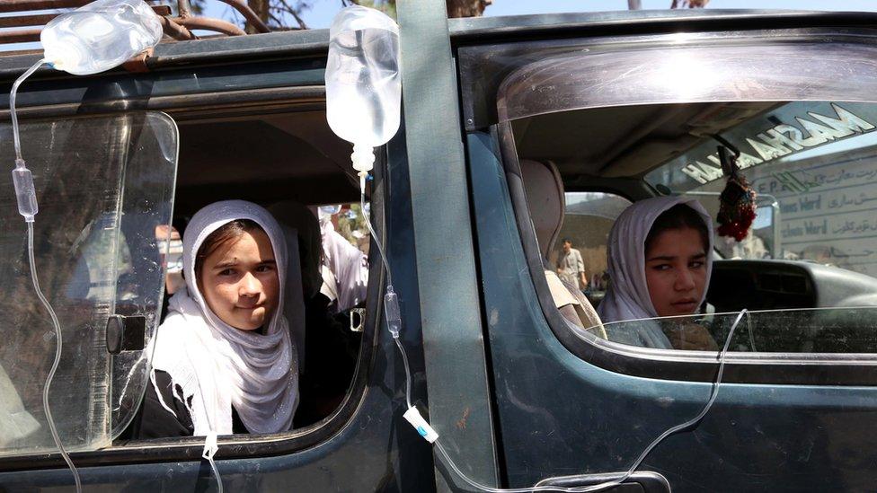 Afghan school girls receive medical treatment outside a local hospital after being admitted for symptoms of poisoning, in Herat, Afghanistan, 07 September 2015