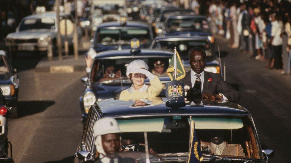 The Queen alongside President of Kenya Daniel arap Moi (1924-2020) in the motorcade after her arrival in Nairobi, Kenya, 10th November 1983. Prince Philip and Queen Elizabeth II are on a four-day State Visit to Kenya