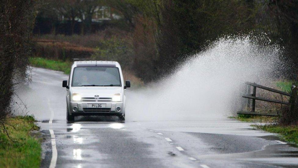 Car driving through a puddle