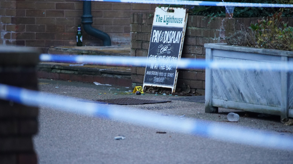 Crime scene tape and evidence markers at the Lighthouse pub