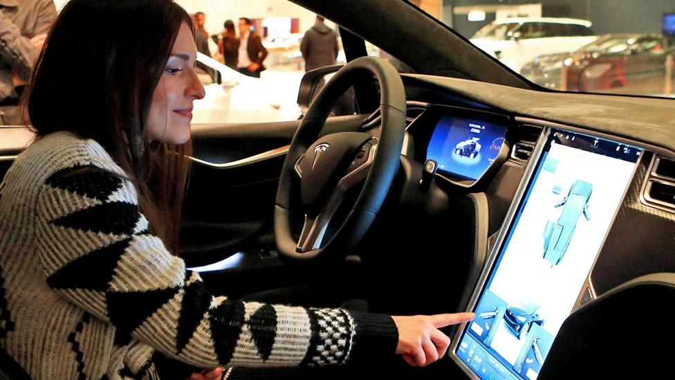 A woman in a Tesla