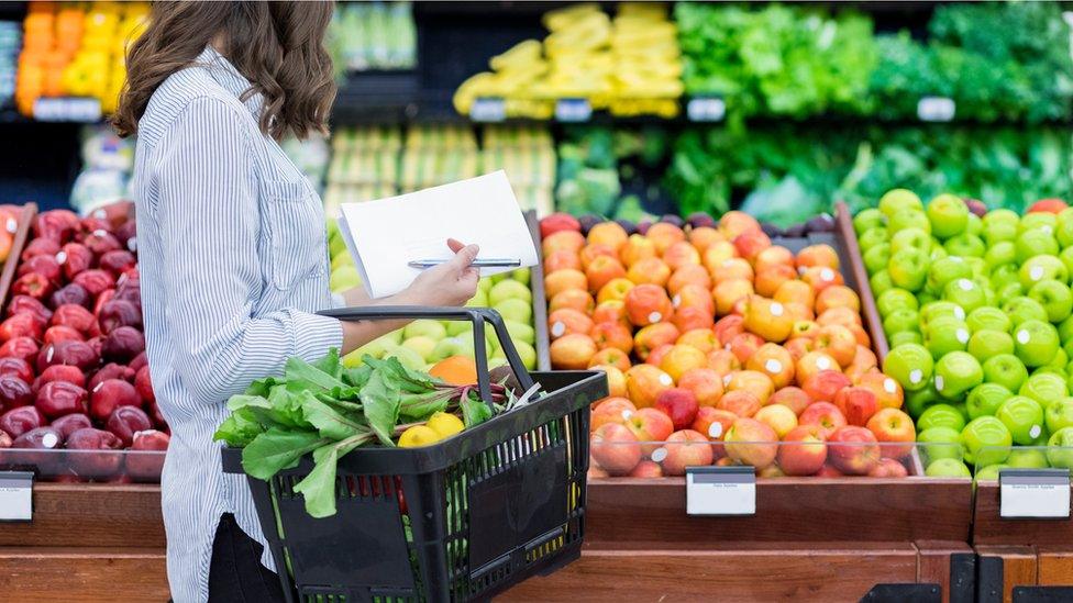 A woman buying fruit and vegetables