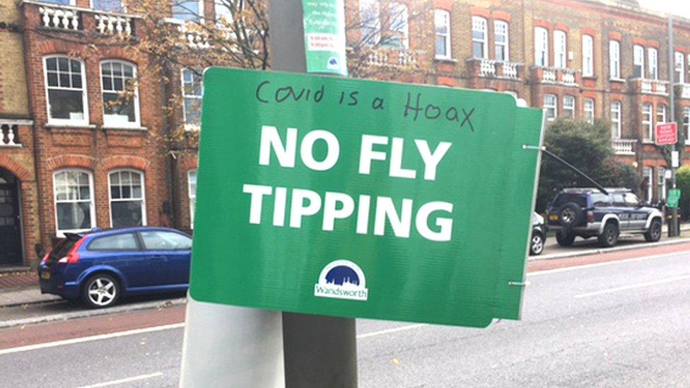 "Covid is a hoax" written on a sign that says No Fly Tipping