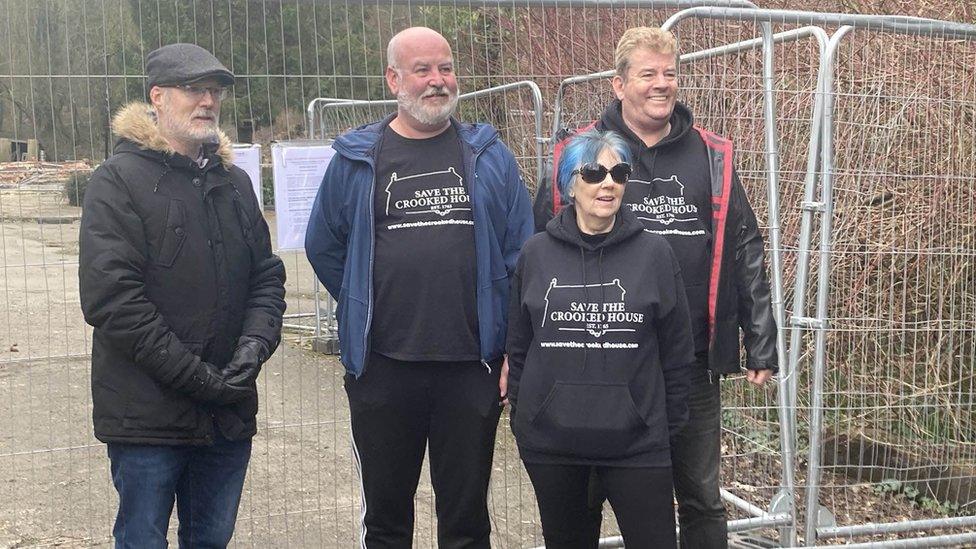 A group of campaigners standing outside the site of the pub