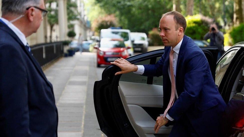 Former British Health Secretary Matt Hancock walks through a door after testifying at the COVID-19 Inquiry