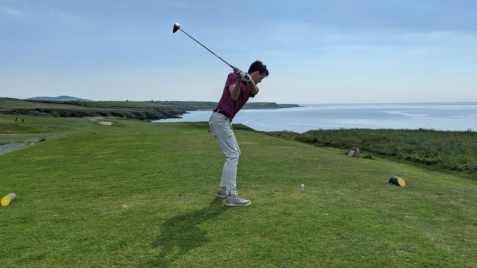 Ben Peters playing golf near the sea