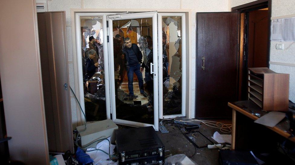 Palestinians inspect the damage inside the office of Palestine TV, in Gaza City January 4, 2019