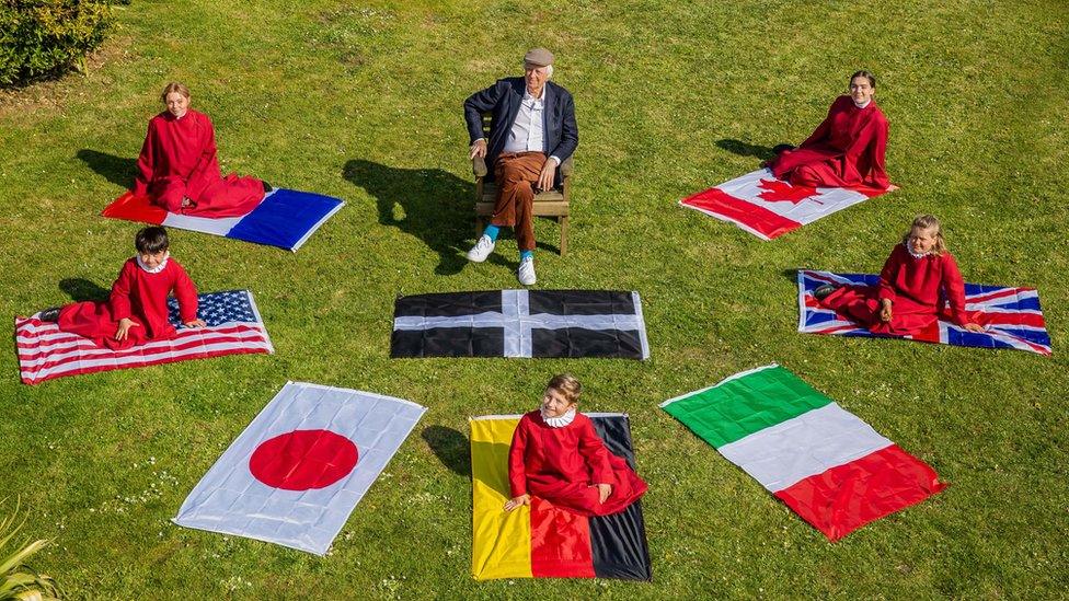 Sir Tim Rice with Truro Cathedral choristers and G7 flags