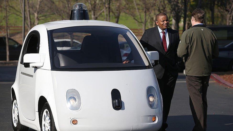 US Transportation Secretary Anthony Foxx inspects a Google self-driving car at the Google headquarters