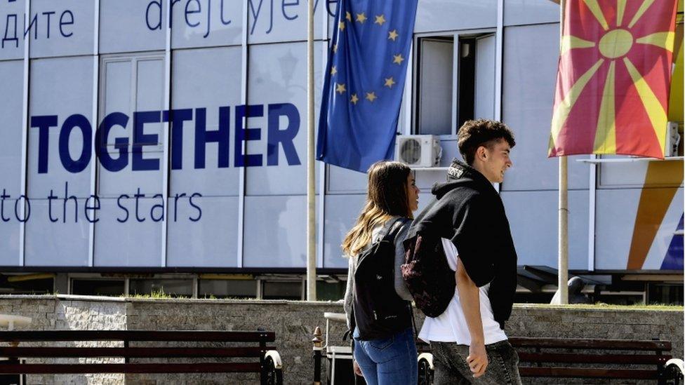 People walk in front of the Ministry for EU integration in Skopje, North Macedonia, 18 October 2019